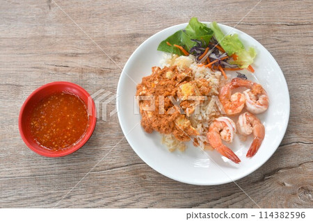 fried shrimp garlic and egg omelet with plain rice couple salad on plate dipping spicy chili sauce cup fried shrimp garlic and egg omelet with plain rice couple salad on plate dipping spicy chili sauce cup 114382596