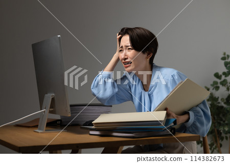 Woman tired from working on a computer 114382673