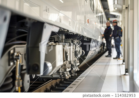 Technicians Inspecting Hydrogen-Powered Train at Maintenance Facility 114382953