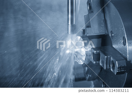 The 4-axis CNC milling machine  cutting the turbocharger part with liquid coolant method. 114383211