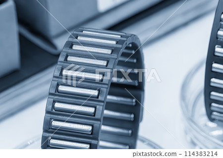 Close up scene the needle rolling  bearing parts in the light blue scene. 114383214