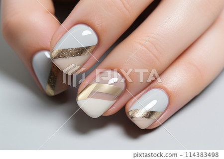 Calm beauty delicate nail design with shiny gold stripes, beautiful female hands with well-groomed neutral manicure 114383498