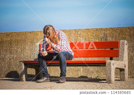 Man outdoor using cell phone Man outdoor using cell phone 114385685