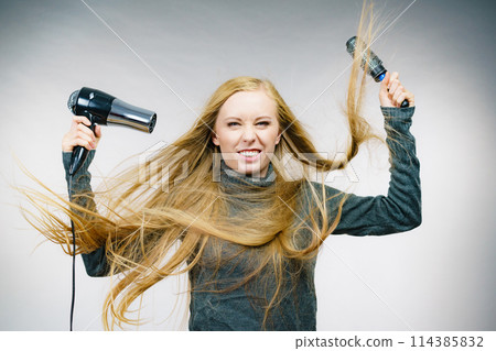 Girl holds hair accessories, styling hair Girl holds hair accessories, styling hair 114385832