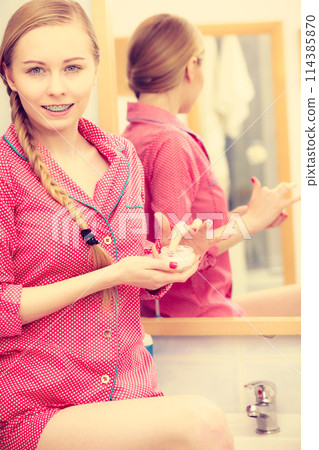 Woman applying moisturizing skin cream. Skincare. 114385870