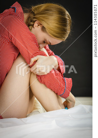 Sad depressed young woman in bed Sad depressed young woman in bed 114385871