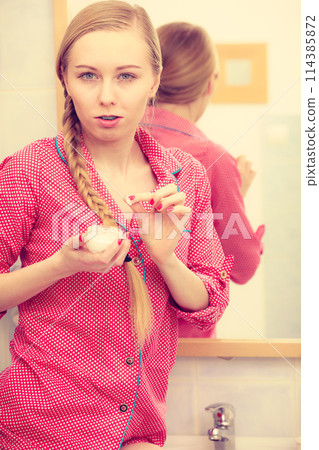 Woman applying moisturizing skin cream. Skincare. 114385872