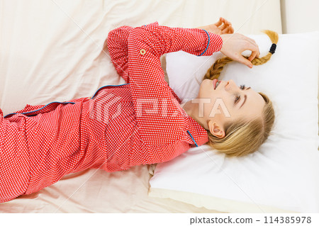 Thoughtful woman lying in bed Thoughtful woman lying in bed 114385978