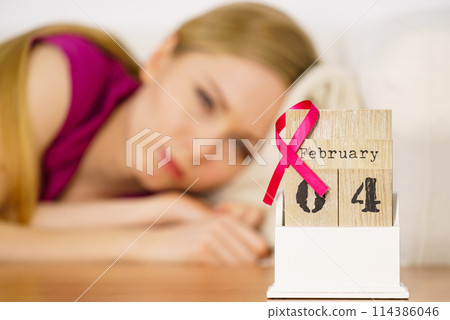 Woman on bed, world breast cancer day on calendar Woman on bed, world breast cancer day on calendar 114386046