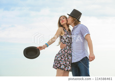 Couple flirting on date, man kissing woman Couple flirting on date, man kissing woman 114386461