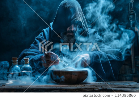 The medieval alchemist make magic ritual at the table in his smoke laboratory. The medieval alchemist make magic ritual at the table in his smoke laboratory. 114386860