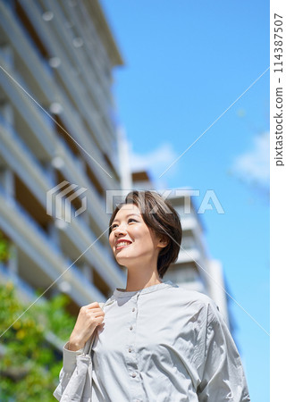 Woman walking down the street with shopping bags Woman walking down the street with shopping bags 114387507