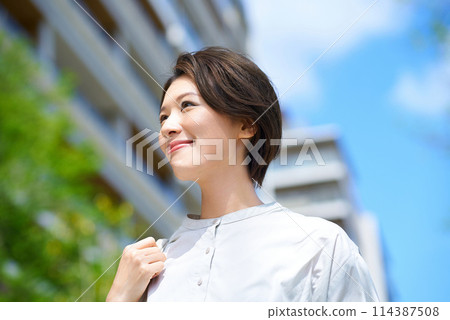 Woman walking down the street with shopping bags Woman walking down the street with shopping bags 114387508