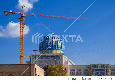 crane on construction site is building a new large mosque Center of Islamic Civilization in Tashkent in Uzbekistan 114388284