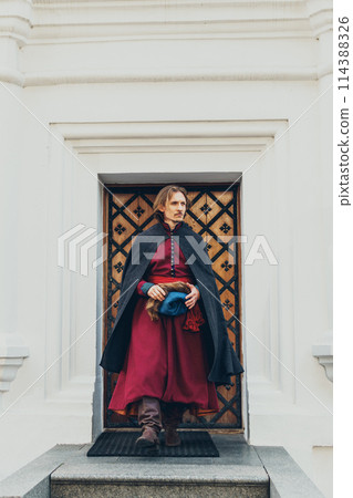 Portrait of a man in a medieval middle class costume. Retro style and historical clothes concepts 114388326