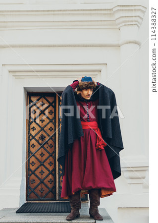 Portrait of a man in a medieval middle class costume. Retro style and historical clothes concepts 114388327