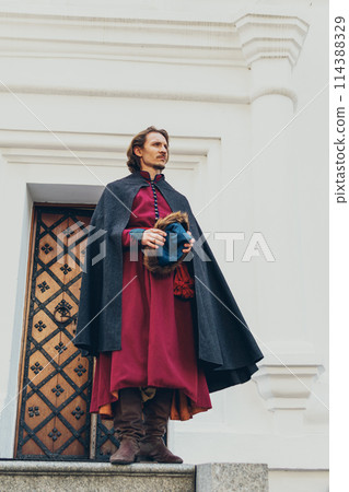 Portrait of a man in a medieval middle class costume. Retro style and historical clothes concepts Portrait of a man in a medieval middle class costume. Retro style and historical clothes concepts 114388329