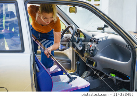 Cleaning car interior with vacuum cleaner Cleaning car interior with vacuum cleaner 114388495