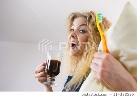 Funny woman being late drinking coffee Funny woman being late drinking coffee 114388550