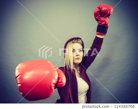 Woman winner wearing boxing gloves Woman winner wearing boxing gloves 114388766