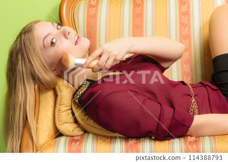 Attractive woman applying make up with brush. 114388793