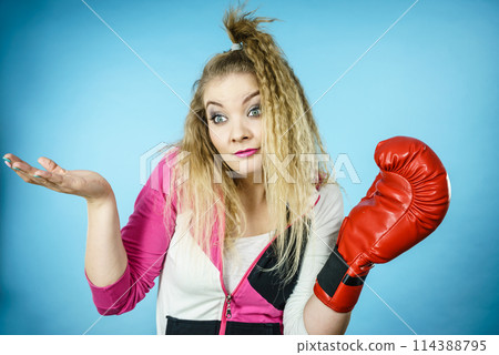 Funny confused woman wearing boxing glove 114388795