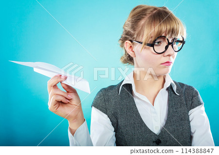 Fly fear. Woman holding airplane in hand. 114388847