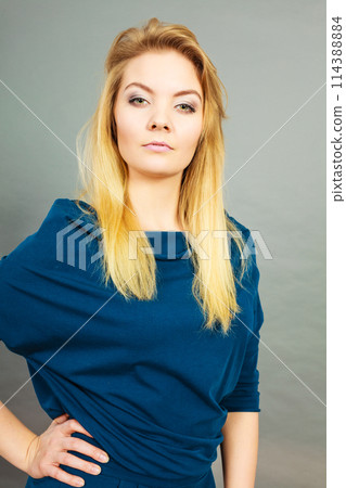 Portrait blonde young woman having serious face expression Portrait blonde young woman having serious face expression 114388884