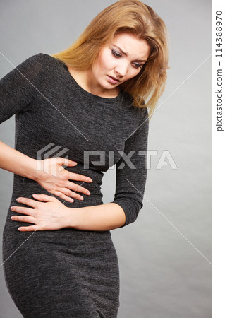 Woman having strong stomach ache. Syndroms Woman having strong stomach ache. Syndroms 114388970