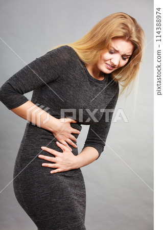Woman having strong stomach ache. Syndroms 114388974