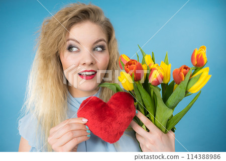 Woman holds tulips and red heart Woman holds tulips and red heart 114388986