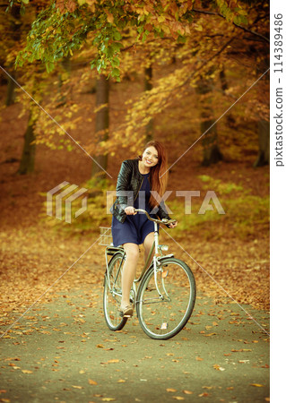 Girl in dress on bike. Girl in dress on bike. 114389486
