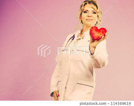 Middle aged blonde doctor enjoy her work. 114389619