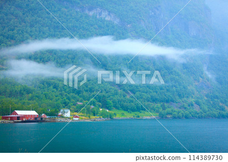Norwegian country houses in the mountains on lake shore 114389730