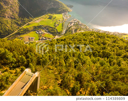 Tourist enjoying fjord view on Stegastein viewpoint Norway 114389809