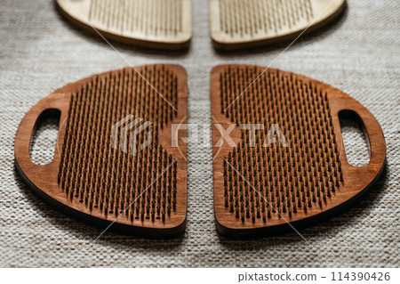 Elegant wooden acupressure boards with focused light and shadow contrasts 114390426