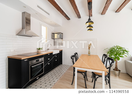 Cozy kitchen with dining table and appliances in apartment Cozy kitchen with dining table and appliances in apartment 114390558