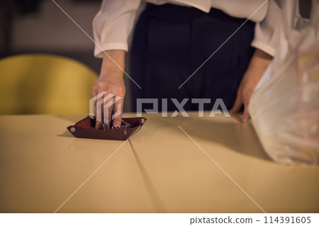 Night routine of a business woman who takes off her jacket and watch 114391605