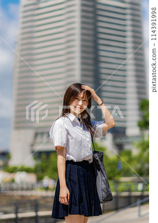 High school girl walking through an office district 114391998