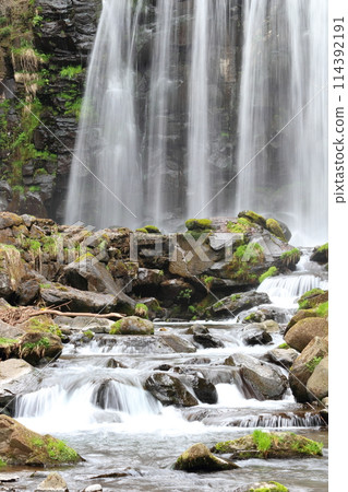 Waterfall splashes and negative ions from a cool, clear stream 114392191