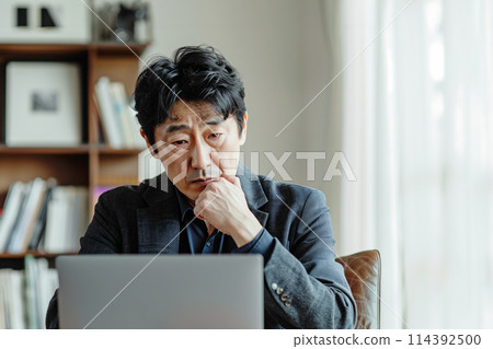 AI image of a man thinking while working remotely AI image of a man thinking while working remotely 114392500