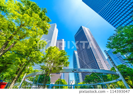 Shinjuku, Tokyo cityscape in Japan. View of Nishi-Shinjuku sign at the intersection behind Shinjuku Police Station and skyscrapers, April 28th Shinjuku, Tokyo cityscape in Japan. View of Nishi-Shinjuku sign at the intersection behind Shinjuku Police Station and skyscrapers, April 28th 114393047