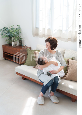 Mother holding a baby 114394242