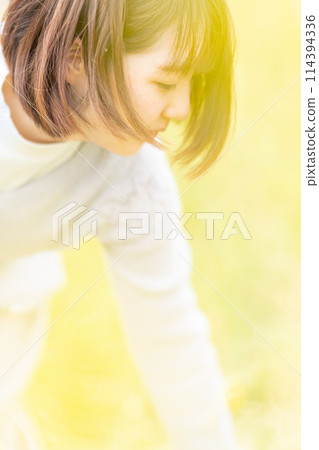 Young woman and rapeseed flowers portrait Young woman and rapeseed flowers portrait 114394336