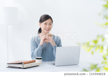 Woman operating a smartphone Woman operating a smartphone 114394628