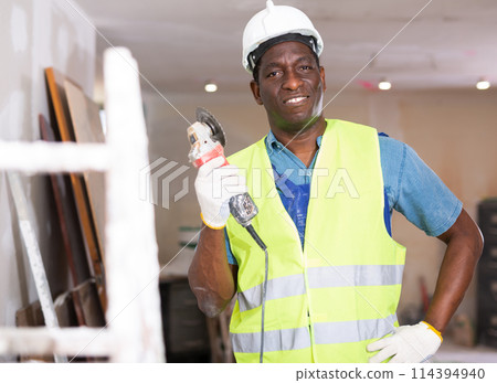 Portrait of african-american worker with an angle grinder in hands 114394940