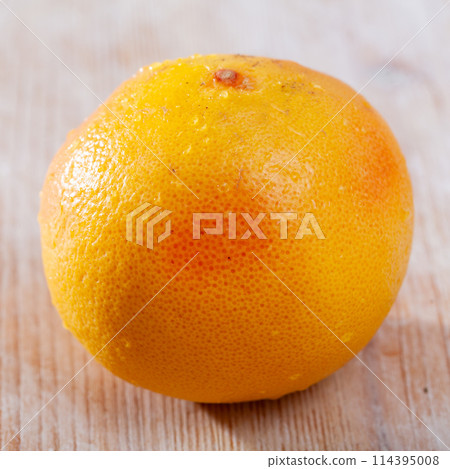 Whole grapefruit on wooden table 114395008