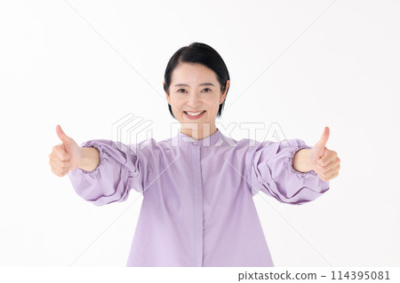 Middle-aged woman portrait thumbs up 114395081