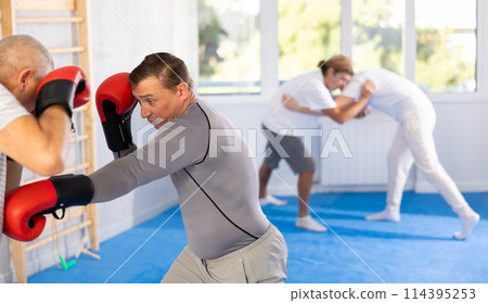 Two men training boxing fight in studio 114395253