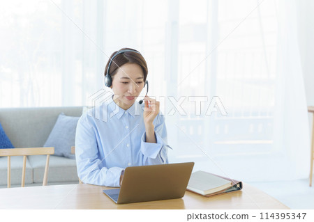 A woman teleworking in the living room 114395347